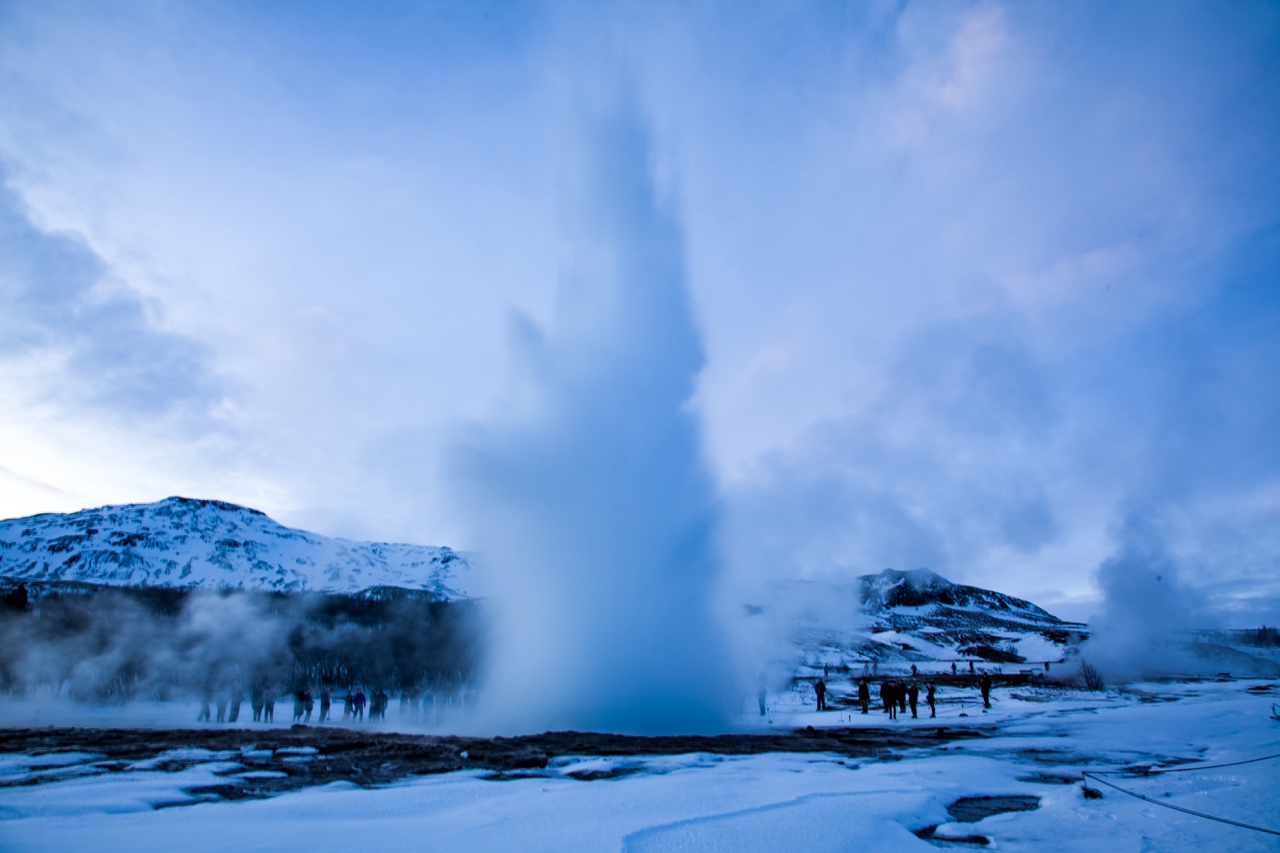 Geyser rising in a snowy Icelandic landscape
